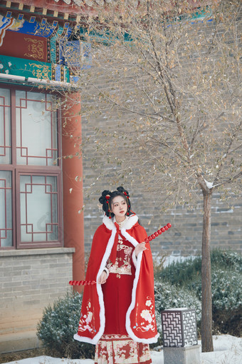 雪天户外身穿中式红色汉服的亚洲少女