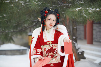 雪天户外身穿中式红色汉服的亚洲少女