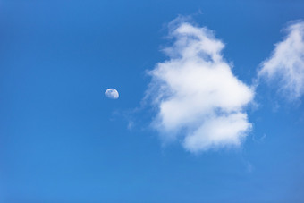 白色的云朵与月亮相伴