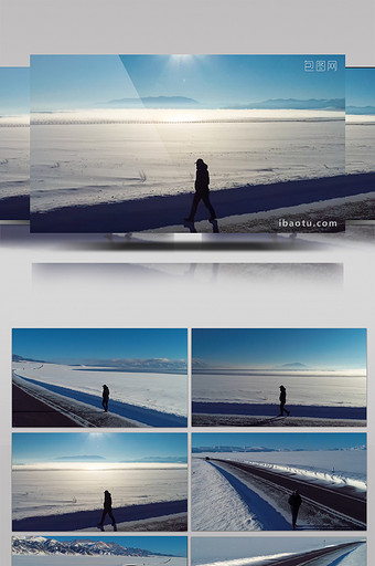 赛里木湖雪景中一个人在公路上行走图片