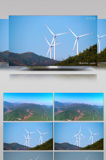 航拍群山间转动的风力发电站图片