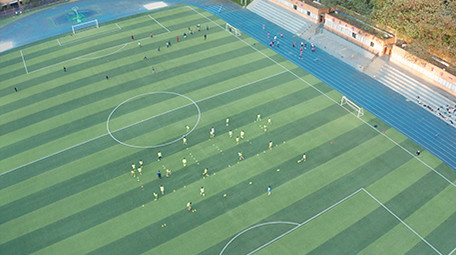 航拍校园操场学生踢球运动