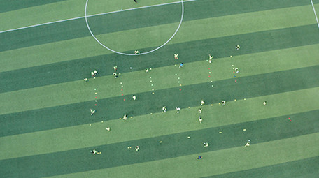 航拍校园操场学生踢球运动