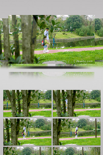 4k公园里爸爸拉着女儿一起欢快走路跳跃图片
