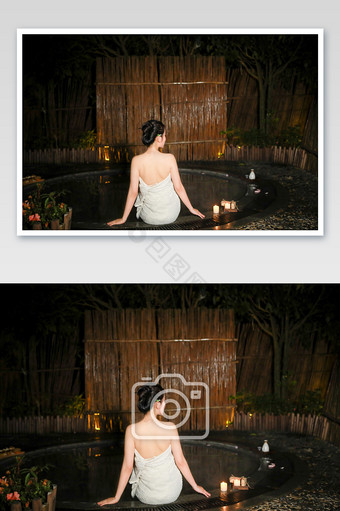 美女泡温泉坐在温泉池边休息的背影图片