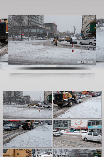 暴雪天气城市交通不畅重型车辆清楚路面积雪图片