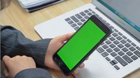 商务办公人员观看笔记本电脑手机绿屏实拍
