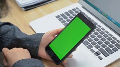 商务办公人员观看笔记本电脑手机绿屏实拍