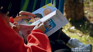 户外母婴亲子坐在吊床上阅读看书