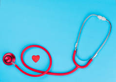 医疗器械: 蓝色背景红色听诊器。世界卫生日。医学概念.
