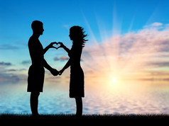 爱夫妇显示心脏符号的手上