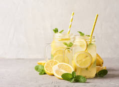 新鲜可口柠檬水在梅森玻璃罐子在白色具体背景