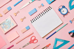 平面奠定蓝色和粉红色的学习用品和空白笔记本隔离在粉红色