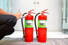 消防队员正在检查灭火器水箱中的消防应急安全救援和消防训练的建筑概念