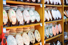 Rows of traditional Chinese tea on shelves at tea shop, Lijiang