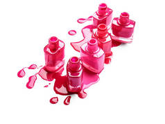 Opened bottles with spilled nail polishes on white background