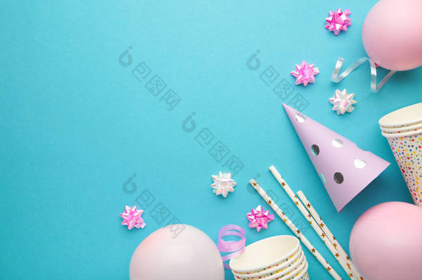 Colorful carnival or party frame of balloons, streamers and confetti on blue background. Space for t