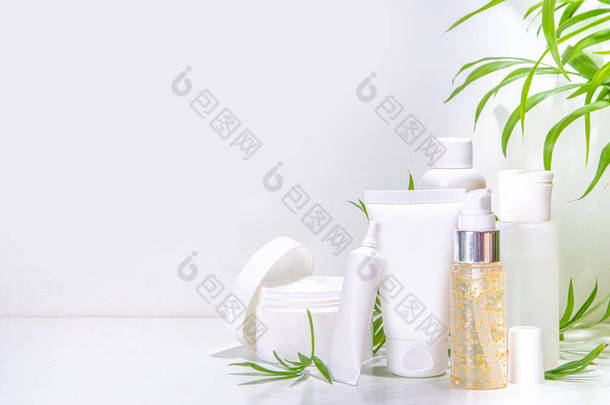 热带棕榈叶扁平复制空间的白色背景美容护肤产品。一套白色的罐子,管子,投水器和瓶子.夏季温泉，日常自然护肤常规理念