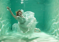 热苗条的白种人妇女摆在水下美丽的衣服独自在深
