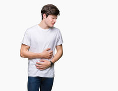 年轻英俊的男人穿着休闲白色 t恤在孤立的背景与手在胃, 因为恶心, 痛苦的疾病感到不适。ache 概念.