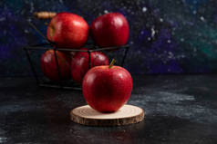 黑色底色的金属篮里的红苹果。高质量的照片