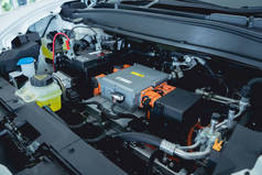 Electric vehicle with open hood and details of electric car engine.