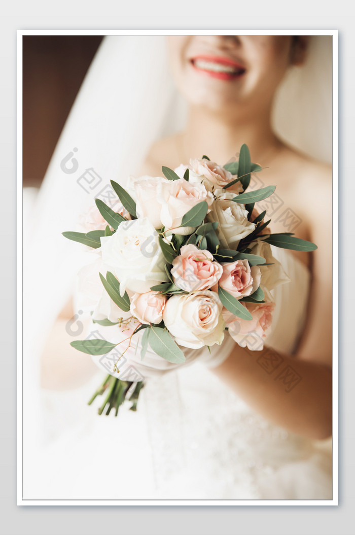 暖色调手拿捧花的幸福新娘图片图片