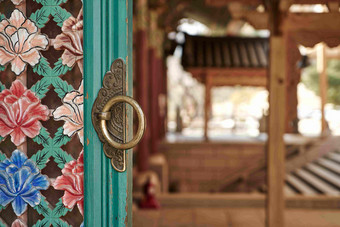 佛教彩色雕花门框铜环门环建筑摄影图