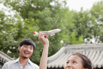 小女孩玩飞机父亲爸爸男人家庭温馨的摄影图