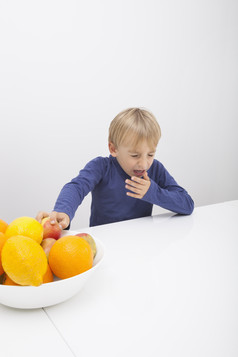简约风吃水果的孩子摄影图