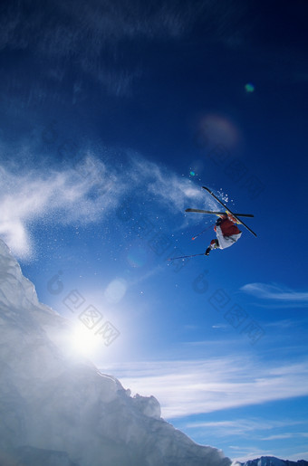 蓝色调腾空的滑雪者摄影图
