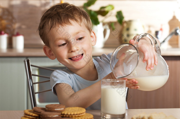 健康的孩子倒牛奶从水罐