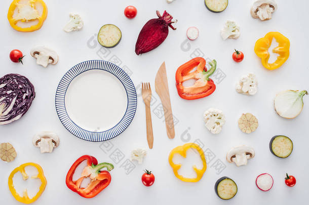 空圆板, 木制叉子与刀和新鲜切片蔬菜在白色分离的顶部视图