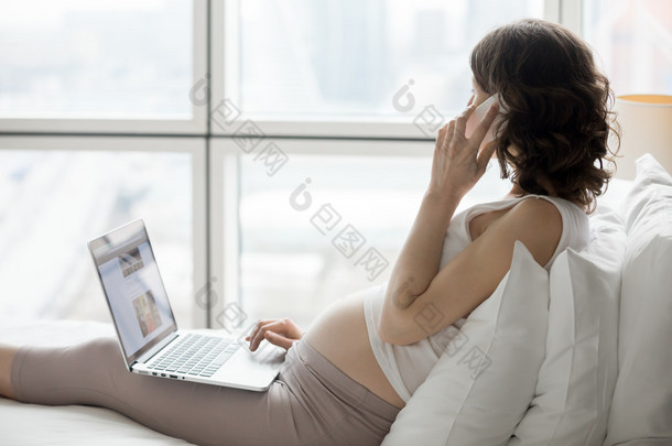 Pregnant woman using technology devices