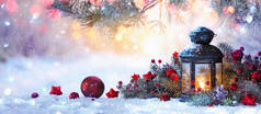  圣诞灯笼挂在雪地上,枝条在阳光下.冬季装修背景
