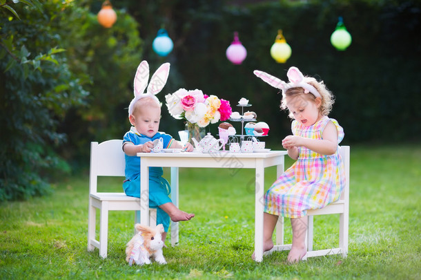 Kids playing Easter tea <strong>party</strong> with toys