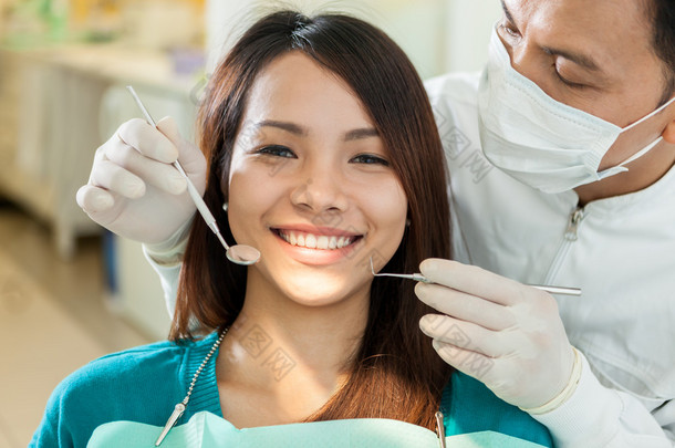坐在牙医的微笑亚洲女人的画像