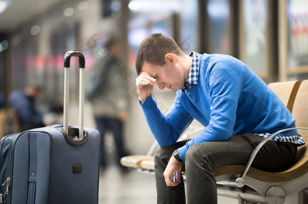 Young frustrated man at airport