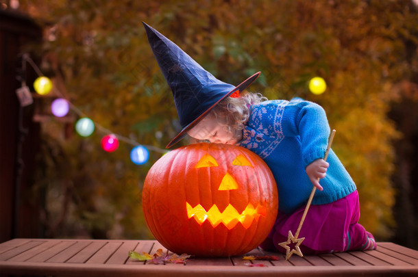 Kids carving pumpkin at Halloween