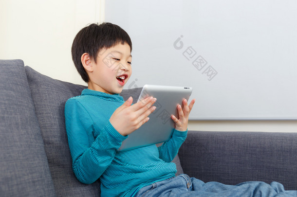 亚洲的小男孩，在平板电脑上玩游戏