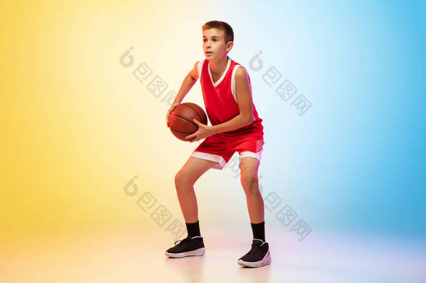 具有渐变背景的年轻篮球运动员的全长肖像