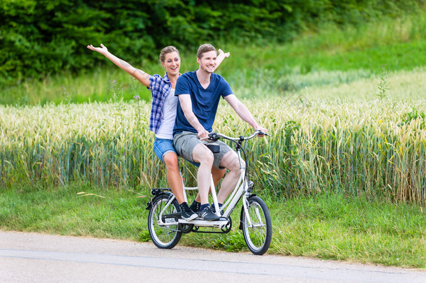 在这个国家一起夫妇骑双人自行车