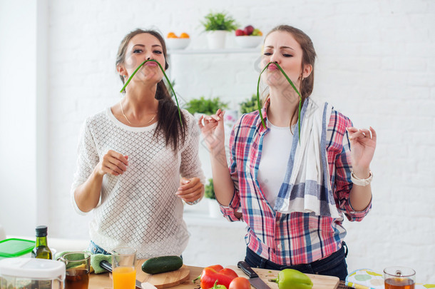准备健康食品的妇女在厨房里与蔬菜玩耍，享受有趣的节食营养概念