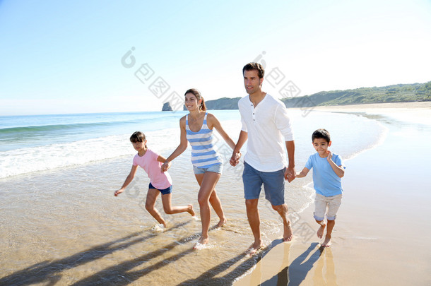家人很开心在海滩上运行