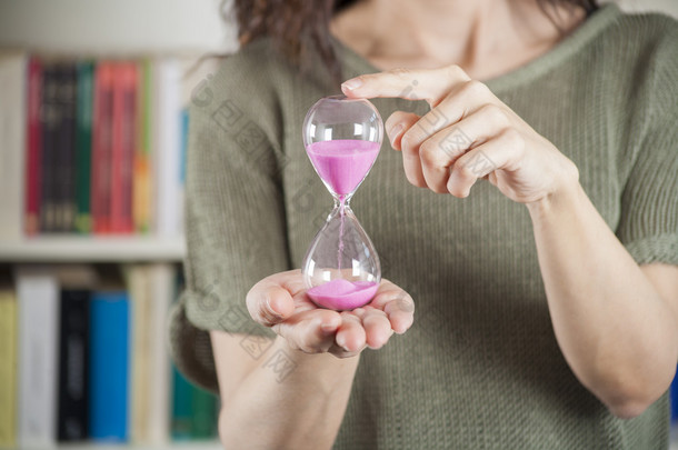 woman with pink sand clock