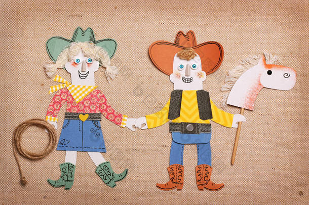 牛仔和女牛仔在西式服装与套索和 skick 马玩具。纸张应用