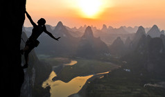 女运动员对中国高山的夕阳的剪影