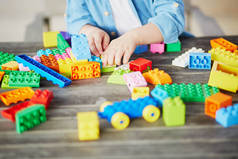 小男孩玩彩色塑料建筑积木