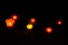 烛灯笼漂浮在河中，在夜晚五颜六色的倒影中.
