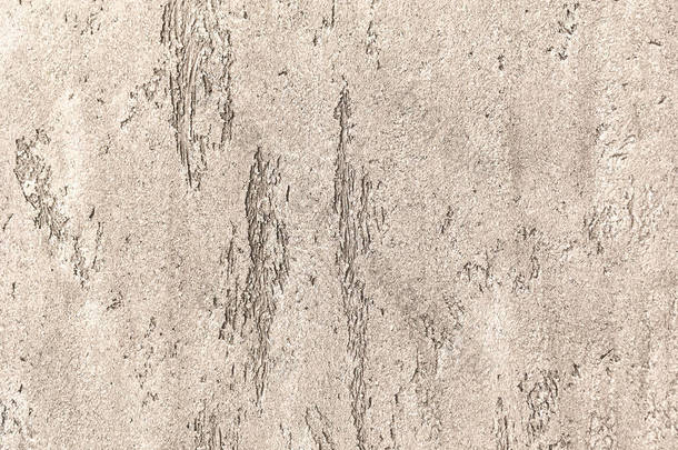 老光棕色墙上贴满了破旧的不均匀石膏。纹理的老式青铜石材表面，特写